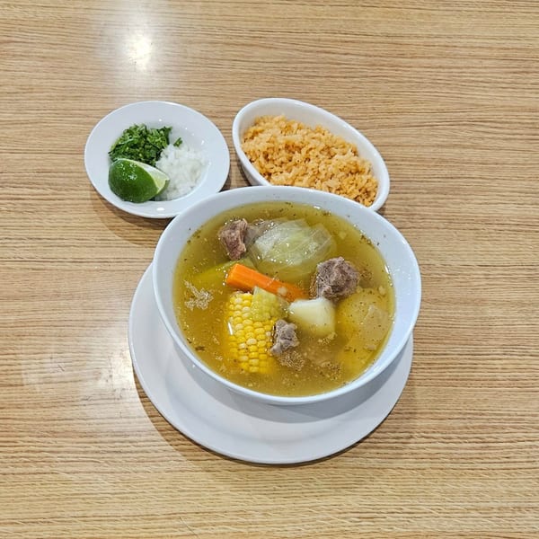 Hacienda Jalisco's beef soup with corn, carrots, and potatoes, served with rice, cilantro, onions, and lime.