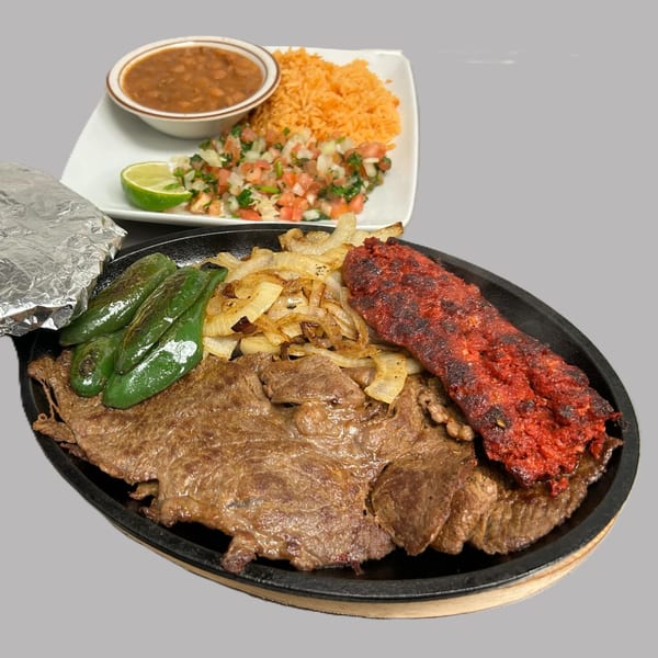 Hacienda Jalisco's sizzling platter with steak, chorizo, grilled peppers, onions, rice, beans, and pico de gallo.